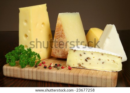 Variety of cheese: camembert, gouda, brie with nuts, parmesan, goat, sheep and other hard cheeses