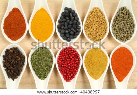 Spices and herbs in white ceramic bowls. Food and cuisine ingredients. Colorful natural additives.