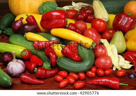 Organic produce. Autumn harvest - ripe vegetables and fruits. Tomatoes, plums, pepper, raspberries, zucchini, pears and other food.