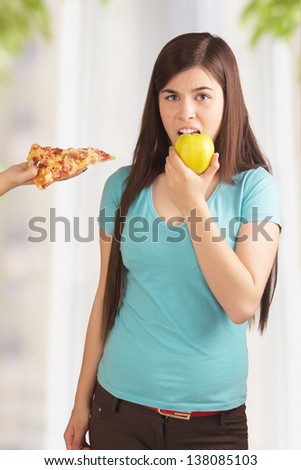 Woman eat fruit instead of fastfood pizza, healthy vitamin food and diet concept