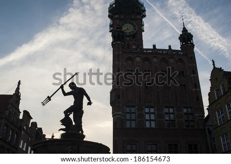 Low light view of the City Hall tower with the clock and the statue of Neptune, symbol of Gdansk/Symbol of Gdansk/Poland, Gdansk, 2011 City Hall tower and statue on the main old city street.