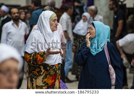 Chatting after Ramadan prayer/Sarajevo, Bosnia, July 11, 2013 Two muslim women are chatting after the end of the 5 o\'clock prayer of the day, during Ramadan month in the Old Town Mosque.