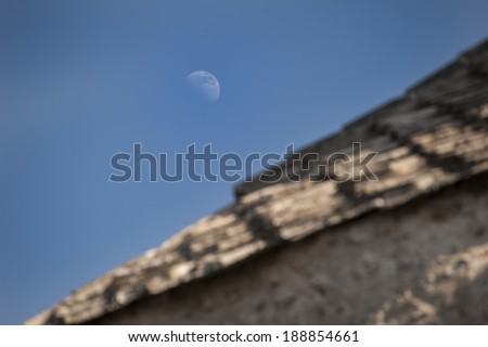 Moon over a Mostar roof/Moon rising over a stone roof in Mostar. Bosnia, Mostar, July 17, 2013