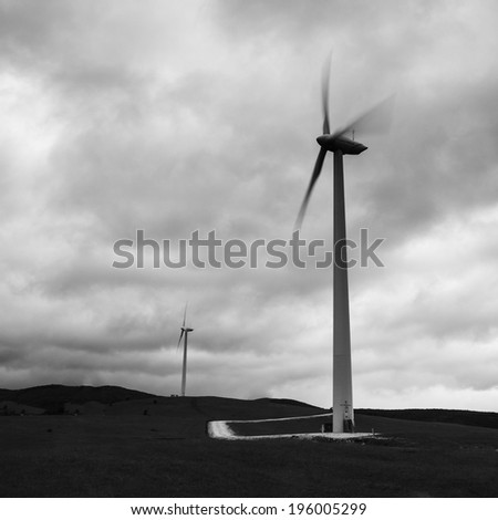 Wind mills/View of two wind mills in a windy region in south west Romania, close to the river Danube. Orsova, Romania, May 16, 2010