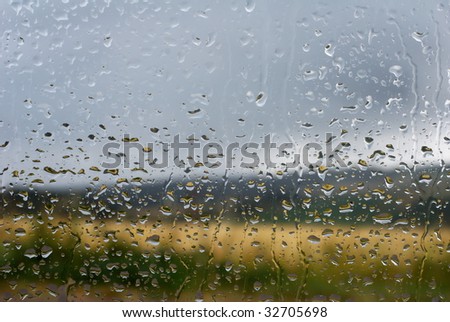 Water drops on window on a grey rainy day