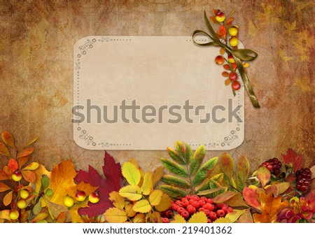 Border of autumn leaves and berries with a card on a vintage background