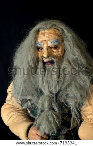 Scary Halloween mask of an old man with long gray hair and beard