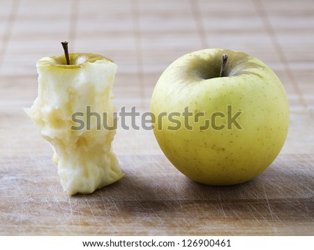 Two apples. In the photo you can see a whole apple next to the remains of another apple.