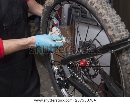 Detail of a mechanic repairing a mountain bike in a workshop