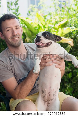 Man holding his dog, a beautiful French bulldog female