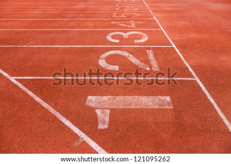 red running track field with white lines