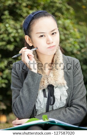 asian female studying in the park