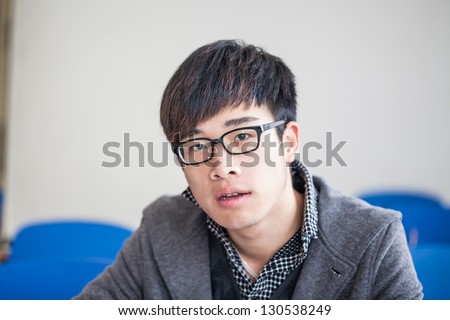 asian chinese male student studying in classroom