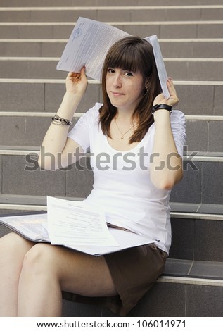 Young business woman outdoor with financial papers