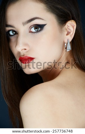 portrait of luxury beauty brunette girl with diamond ear rings and red lips