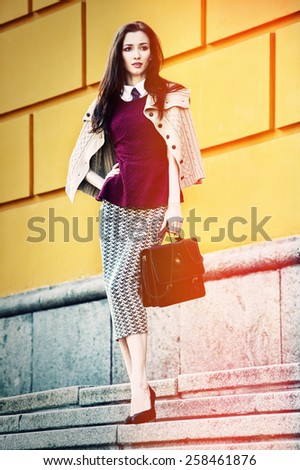 stylish business woman on stairs city street portrait (analog film imitation)