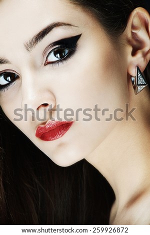 luxury beauty brunette girl with diamond ear rings and fashion make-up