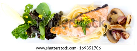 Grilled salmon with pasta on top view