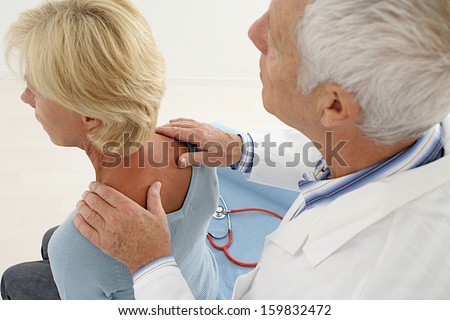 doctor and patient-  medical visit for senior woman focus on the neck and back desease