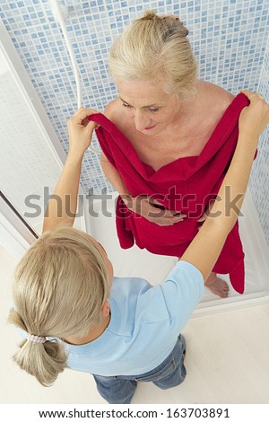 home help assisting elderly woman for shower