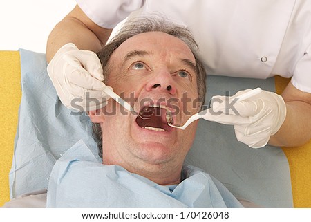 Senior female Dentist Examining senior male Patient
