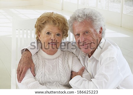 Happy elderly couple hugging in front of the camera