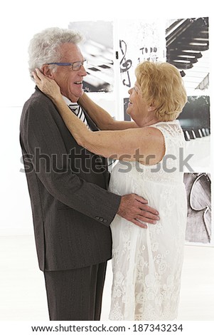 Beautiful senior couple dressed up and dancing together with tenderness