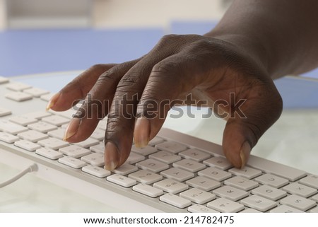 Close-up of African female typing on keyboard