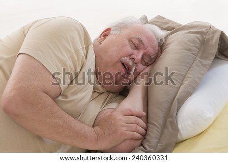 Close up of senior man sleeping and Snoring in bed
