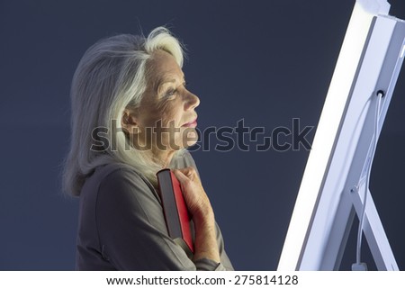 Light therapy-Senior woman getting face photo-therapy treatment