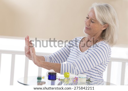 beautiful mature woman showing her hands after treatment
