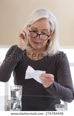 Senior woman reading medical informations
