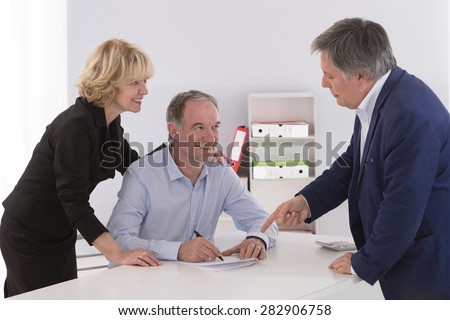 Senior couple writing signature under contract after financial consultation