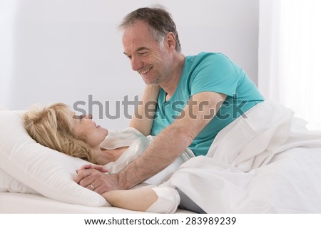 Portrait Of Happy Senior Couple Together In Bed