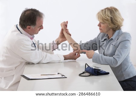 Doctor checking elder female patient