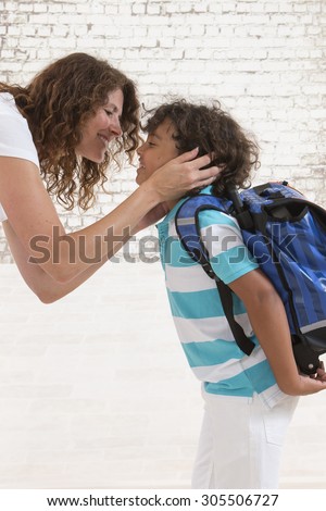 Child hugs mother good-bye before going to school