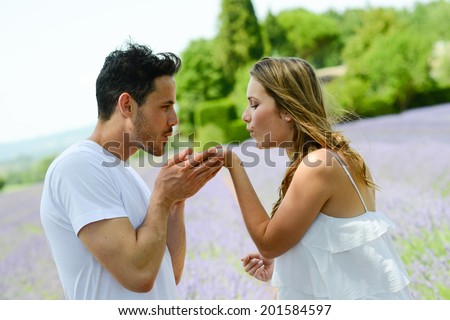 romantic young couple man woman in summer holiday having fun lavender field provence south France