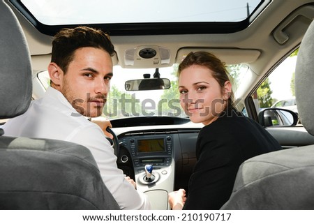 beautiful young business people man and woman driving a rental car for business trip