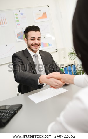 yong businessman in transaction shaking hand with client