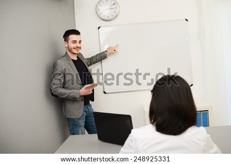 young business man or teacher showing on white board