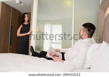 young business couple man and woman in hotel room