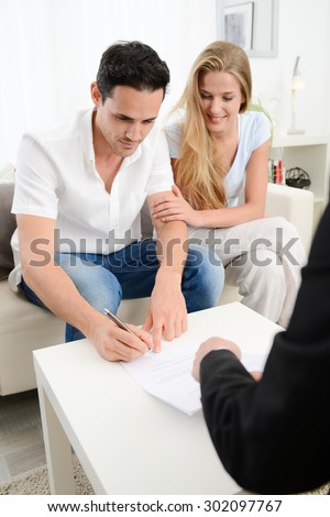 happy young couple at home in transaction signing contract with a business woman