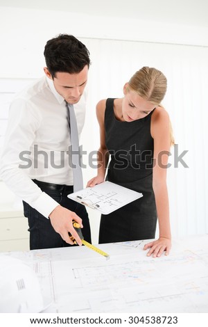 group of business people architect man and woman studying blueprint in office desk