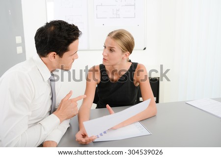 two young business people in meeting office looking at data documents
