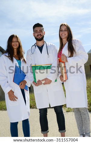 group of young happy medical students boys and girls together on a hospital university campus