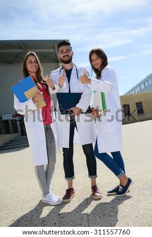 group of young happy medical students boys and girls together on a hospital university campus