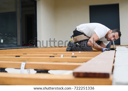 Similar – Image, Stock Photo young handyman installing wooden floor