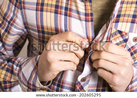 Man tying his shirt on a white background