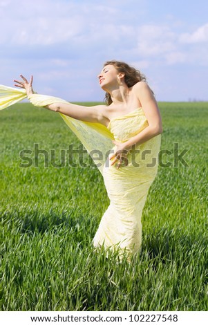 Expressive attractive young woman wrapped in yellow cloth