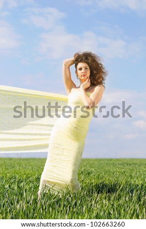 Young cute woman wrapped in yellow cloth